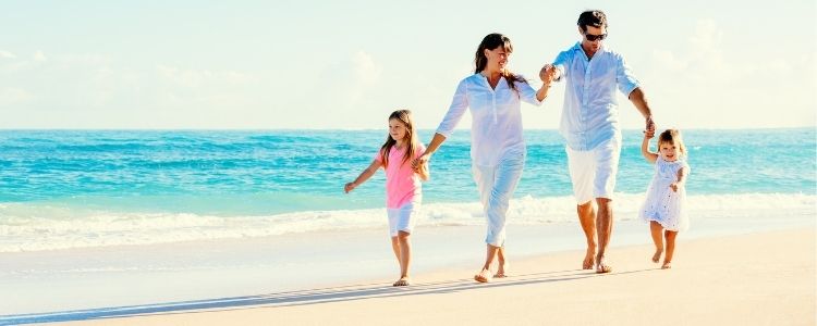 family walking on sunny beach