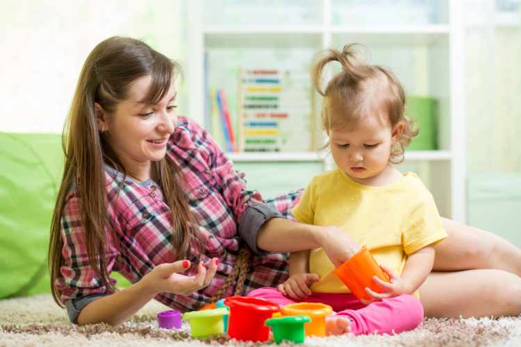 Babysitter playing with young child