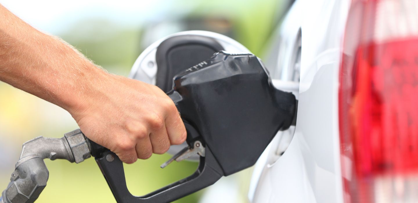 hand pumping gas into car