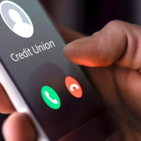 Person holding phone with Credit Union incoming call