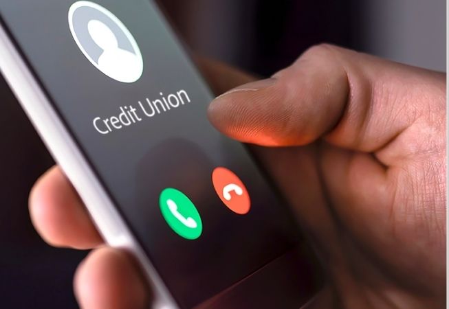 Person holding phone with Credit Union incoming call