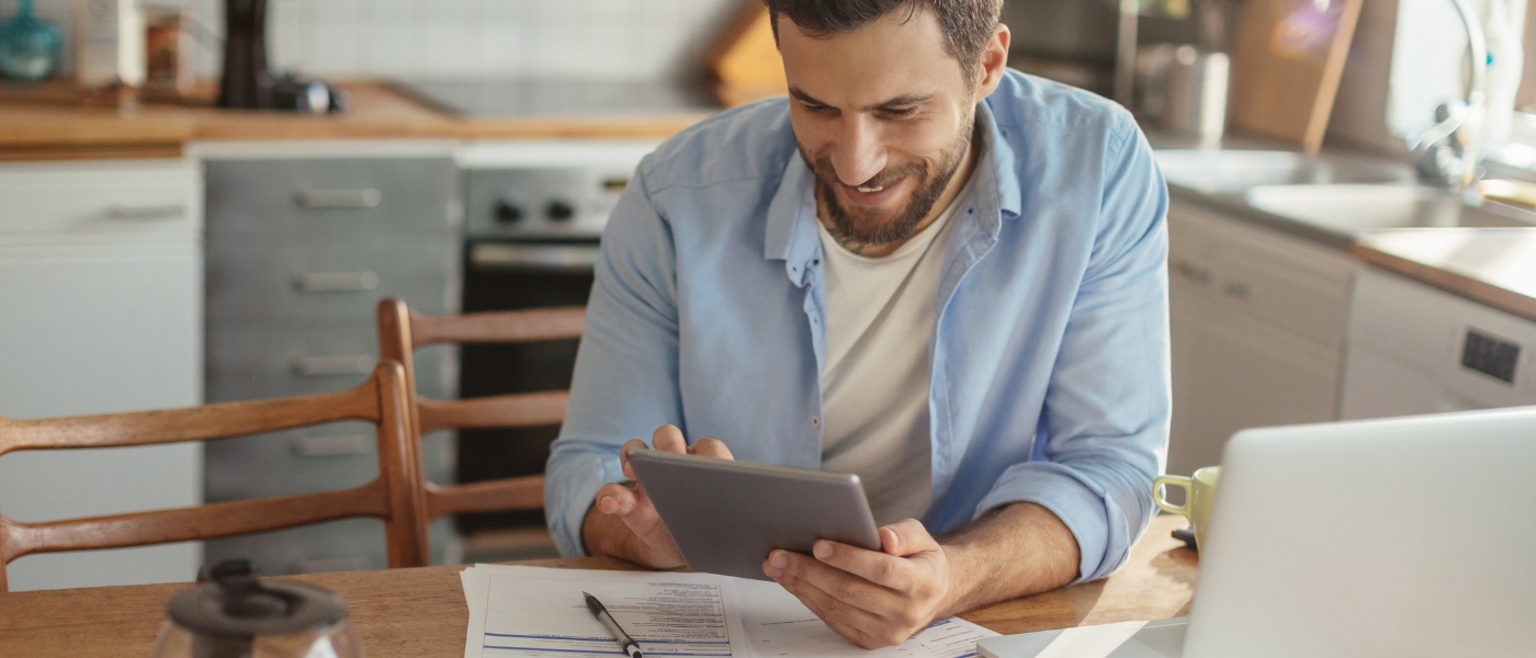 Man paying bills at kitchen table
