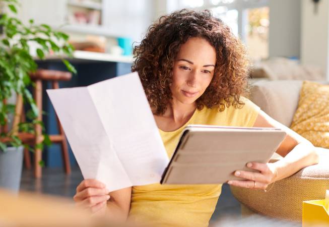Woman reviewing bill with tablet